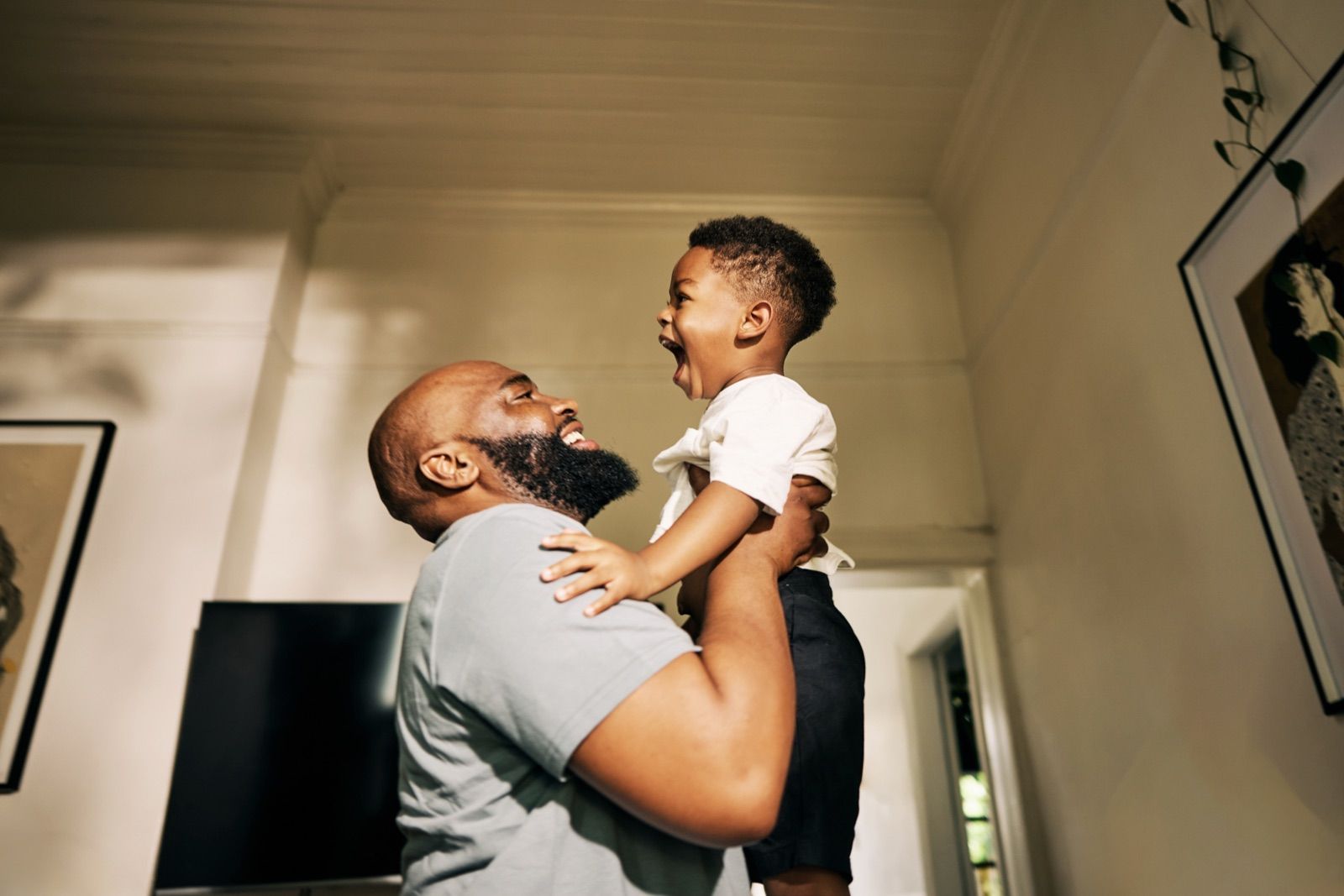 Father lifting his laughing son